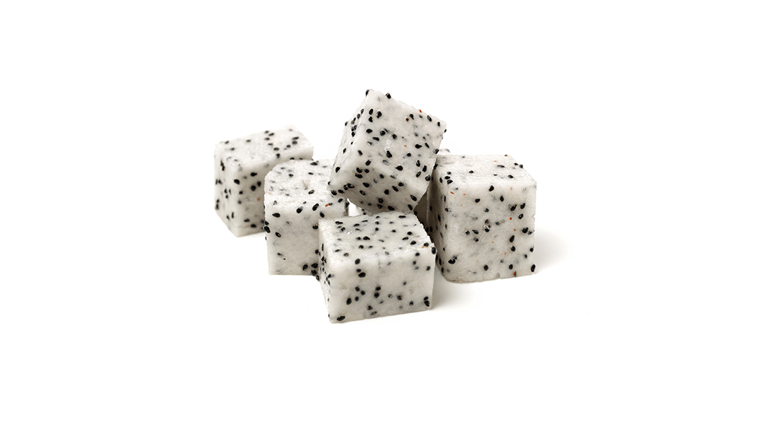 Dragon fruit pieces with white flesh and black seeds