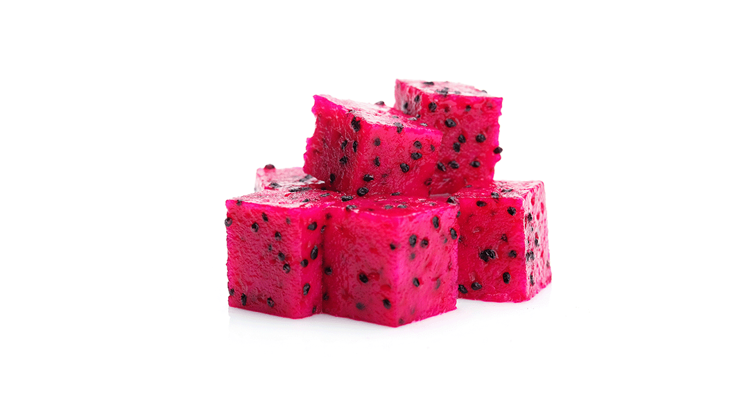 Red dragon fruit pieces with vibrant pink flesh and black seeds